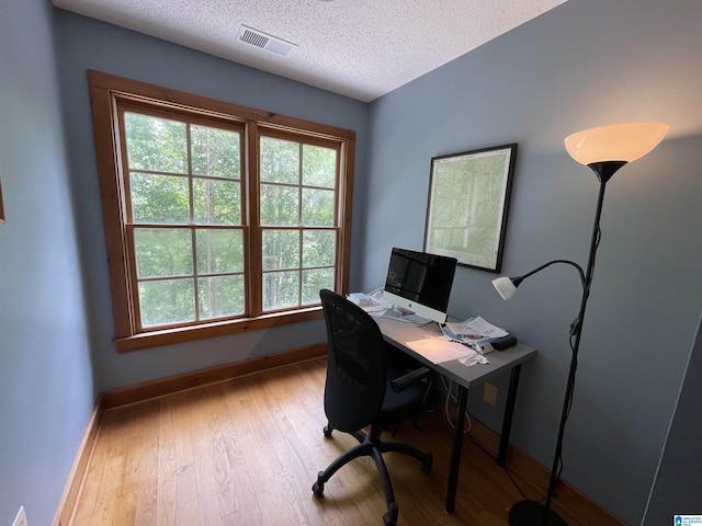 720 Good Hope Delta Rd, Delta, AL 36258 - home office with a textured ceiling, baseboards, and wood finished floors