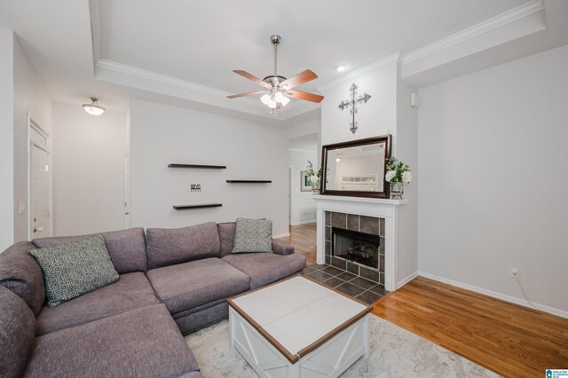 2246 Clairmont Dr, Leeds, AL 35094 - living room with ornamental molding, light wood-style floors, a raised ceiling, ceiling fan, and a fireplace