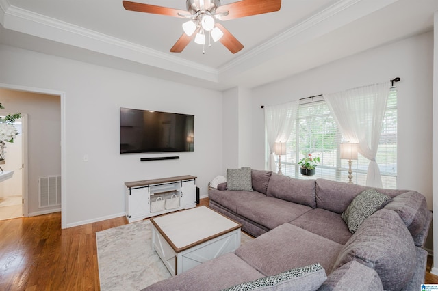2246 Clairmont Dr, Leeds, AL 35094 - living room featuring a tray ceiling, crown molding, wood finished floors, ceiling fan, and baseboards