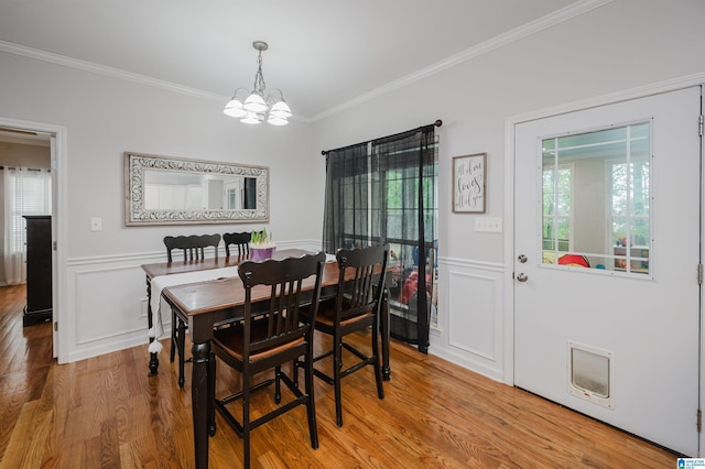 2246 Clairmont Dr, Leeds, AL 35094 - dining area featuring a chandelier, ornamental molding, wood finished floors, a wainscoted wall, and a decorative wall