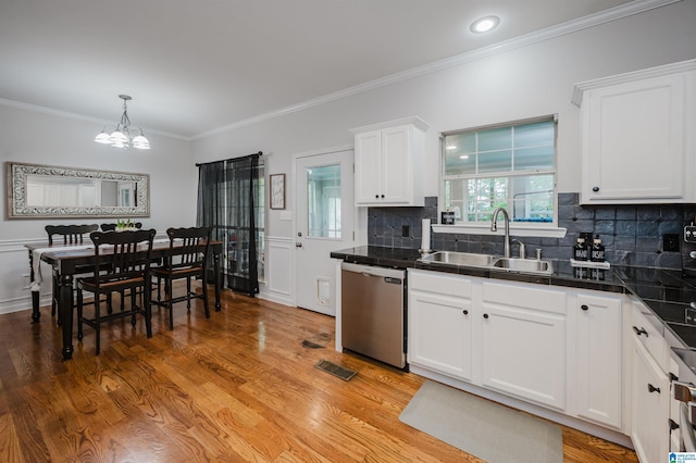 2246 Clairmont Dr, Leeds, AL 35094 - kitchen featuring stainless steel dishwasher, a sink, a chandelier, white cabinets, and ornamental molding