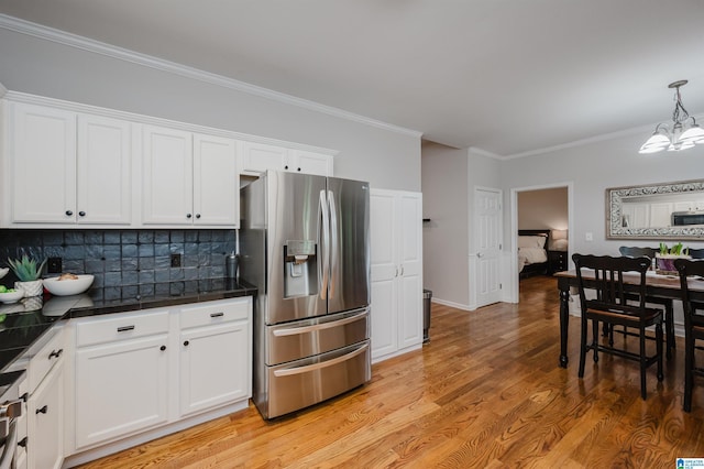 2246 Clairmont Dr, Leeds, AL 35094 - kitchen with stainless steel refrigerator with ice dispenser, a chandelier, white cabinetry, crown molding, and tasteful backsplash