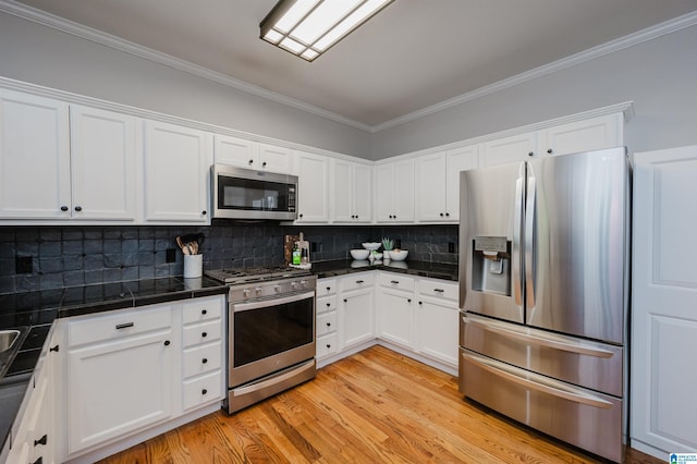 2246 Clairmont Dr, Leeds, AL 35094 - kitchen featuring stainless steel appliances, white cabinetry, light wood-style flooring, ornamental molding, and backsplash