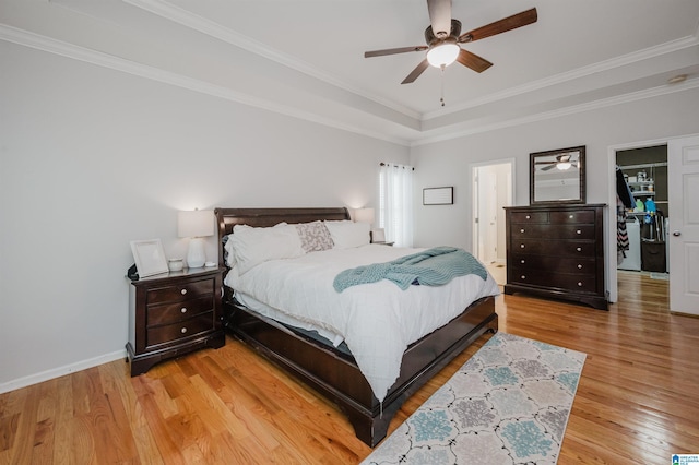 2246 Clairmont Dr, Leeds, AL 35094 - bedroom with light wood-style floors, crown molding, a tray ceiling, baseboards, and ceiling fan
