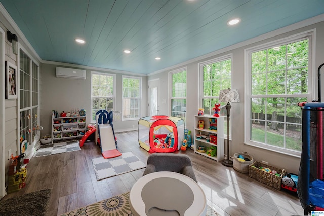 2246 Clairmont Dr, Leeds, AL 35094 - playroom with a wall unit AC, wood finished floors, recessed lighting, crown molding, and baseboards