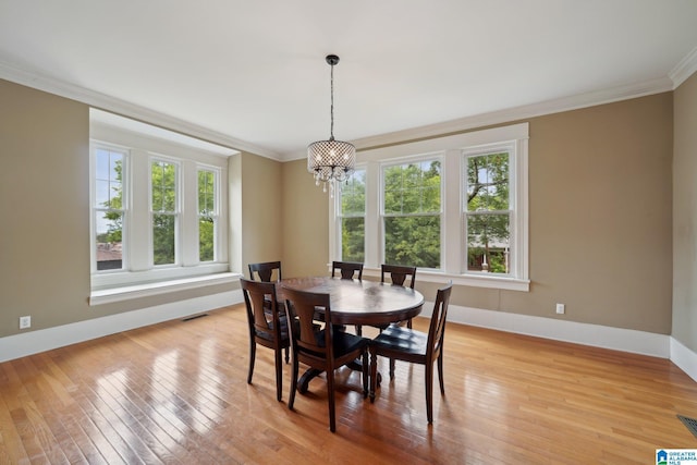 1710 Cullom St S, Birmingham, AL 35205 - dining space with healthy amount of natural light, ornamental molding, a chandelier, and light wood-style floors