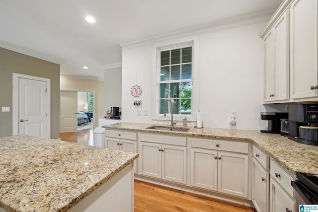 1710 Cullom St S, Birmingham, AL 35205 - kitchen with a sink, crown molding, light wood-type flooring, recessed lighting, and light stone countertops