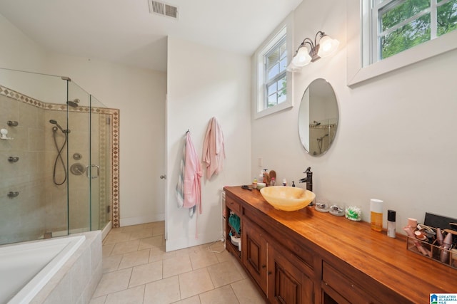 1710 Cullom St S, Birmingham, AL 35205 - bathroom with a shower stall, vanity, tile patterned flooring, a relaxing tiled tub, and baseboards