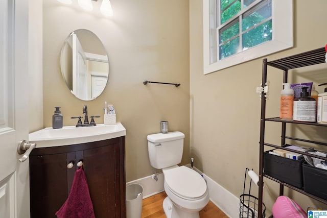 1710 Cullom St S, Birmingham, AL 35205 - half bathroom with vanity, toilet, wood finished floors, and baseboards