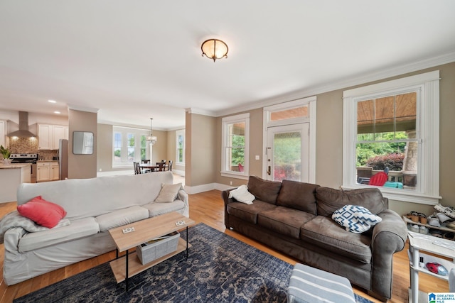 1710 Cullom St S, Birmingham, AL 35205 - living room featuring crown molding, light wood-type flooring, a chandelier, plenty of natural light, and baseboards