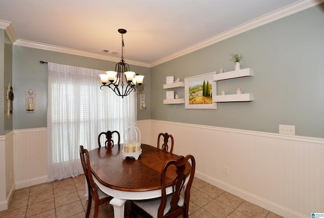 100 Weeping Cir, Wilsonville, AL 35186 - dining room featuring wainscoting, light tile patterned floors, a chandelier, and ornamental molding
