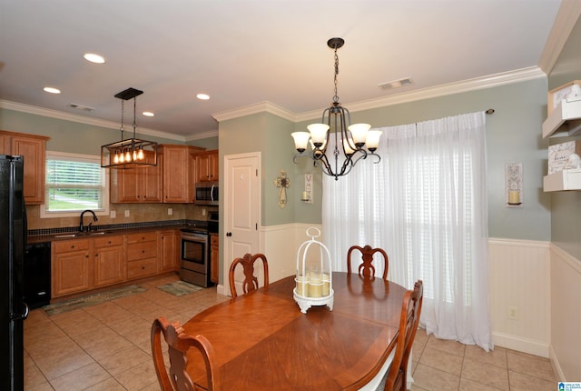 100 Weeping Cir, Wilsonville, AL 35186 - dining room with a chandelier, light tile patterned flooring, wainscoting, crown molding, and recessed lighting