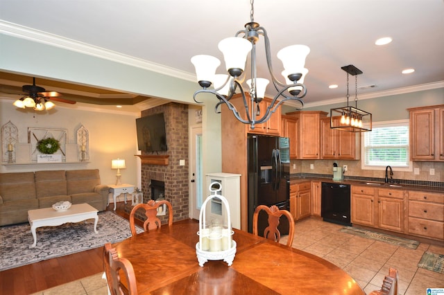 100 Weeping Cir, Wilsonville, AL 35186 - dining space with light tile patterned floors, a chandelier, ornamental molding, a fireplace, and a ceiling fan
