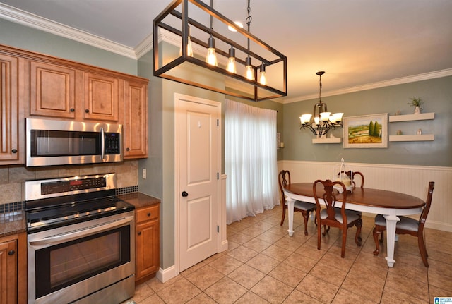 100 Weeping Cir, Wilsonville, AL 35186 - kitchen featuring appliances with stainless steel finishes, a chandelier, crown molding, light tile patterned floors, and backsplash