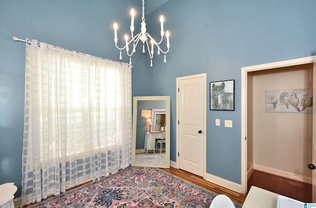100 Weeping Cir, Wilsonville, AL 35186 - bedroom with a chandelier, wood finished floors, and baseboards