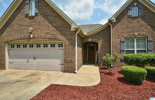 100 Weeping Cir, Wilsonville, AL 35186 - view of front of property featuring driveway, brick siding, an attached garage, and a shingled roof