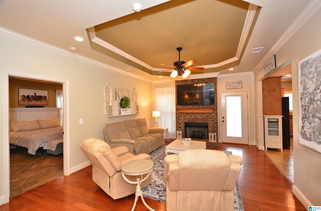 100 Weeping Cir, Wilsonville, AL 35186 - living area featuring a tray ceiling, a ceiling fan, a fireplace, crown molding, and baseboards