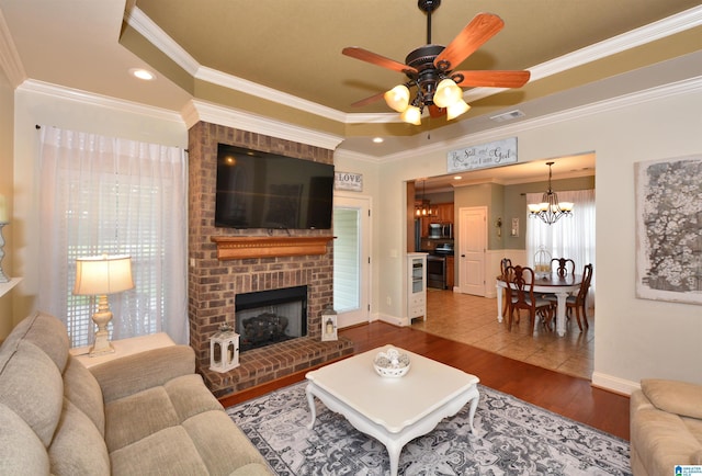 100 Weeping Cir, Wilsonville, AL 35186 - living area with a chandelier, wood finished floors, ornamental molding, a ceiling fan, and baseboards