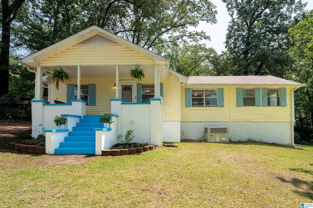 220 Honeysuckle Ln, Gardendale, AL 35071 - bungalow-style house with cooling unit, a front yard, covered porch, and stairway