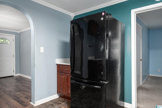 220 Honeysuckle Ln, Gardendale, AL 35071 - kitchen with freestanding refrigerator, arched walkways, a textured ceiling, crown molding, and baseboards