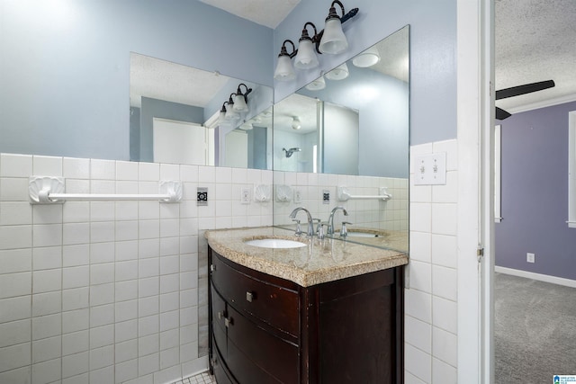 220 Honeysuckle Ln, Gardendale, AL 35071 - bathroom featuring vanity, tile walls, and a textured ceiling