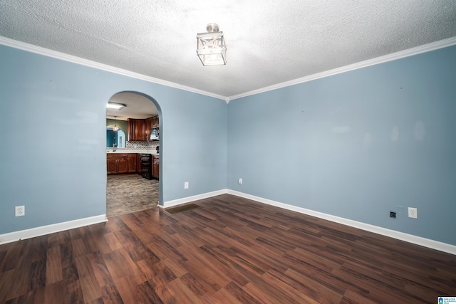 220 Honeysuckle Ln, Gardendale, AL 35071 - unfurnished room featuring arched walkways, dark wood-style flooring, baseboards, crown molding, and a textured ceiling