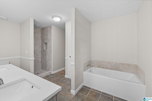 6415 Mays Bend Rd, Pell City, AL 35128 - full bathroom with a bath, tile patterned flooring, double vanity, tiled shower, and a textured ceiling