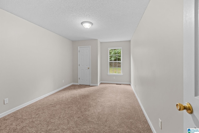 6415 Mays Bend Rd, Pell City, AL 35128 - carpeted spare room featuring a textured ceiling and baseboards
