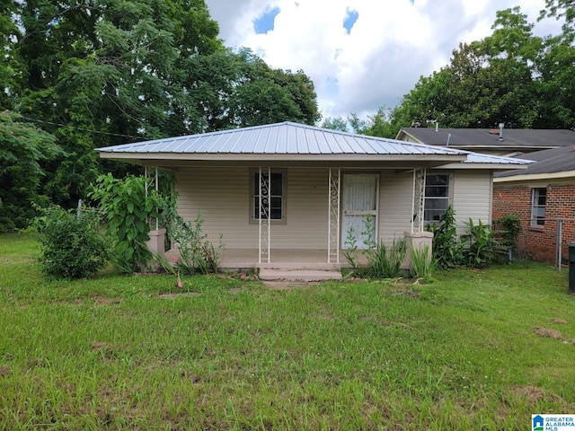 2308 Mayfield Ave, Birmingham, AL 35211 - view of front facade featuring a porch, a front yard, and metal roof