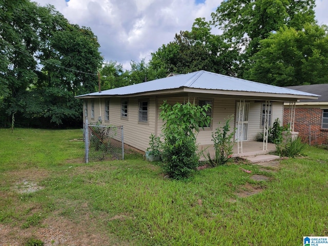 2308 Mayfield Ave, Birmingham, AL 35211 - view of front facade with a front yard, covered porch, and metal roof