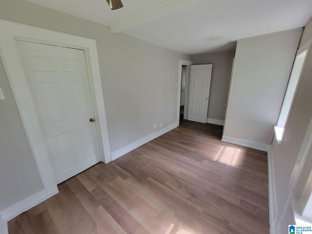 2308 Mayfield Ave, Birmingham, AL 35211 - unfurnished bedroom featuring wood finished floors, beamed ceiling, and baseboards