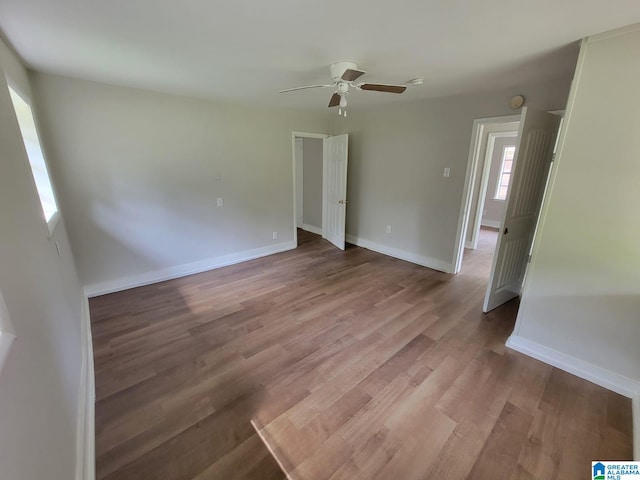 2308 Mayfield Ave, Birmingham, AL 35211 - empty room with light wood-style flooring, a ceiling fan, and baseboards