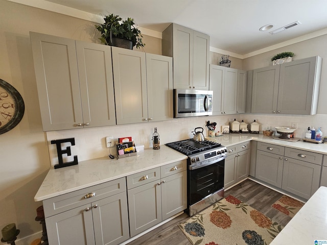 345 Easonville Park Dr, Cropwell, AL 35054 - kitchen featuring appliances with stainless steel finishes, gray cabinetry, dark wood-style floors, tasteful backsplash, and ornamental molding