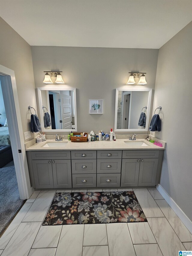 345 Easonville Park Dr, Cropwell, AL 35054 - bathroom featuring marble finish floors, double vanity, ensuite bath, and baseboards