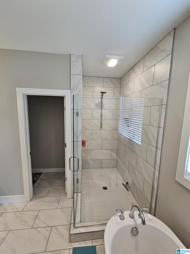 345 Easonville Park Dr, Cropwell, AL 35054 - bathroom featuring a shower stall, marble finish flooring, a tub, and baseboards