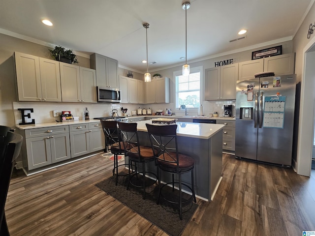 345 Easonville Park Dr, Cropwell, AL 35054 - kitchen with appliances with stainless steel finishes, crown molding, gray cabinetry, light countertops, and a breakfast bar