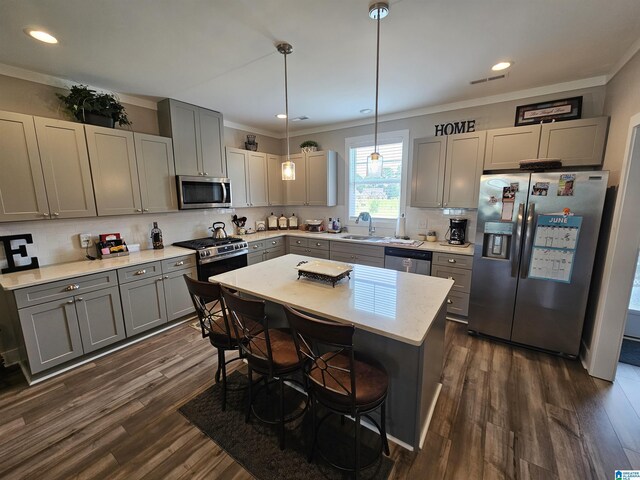 345 Easonville Park Dr, Cropwell, AL 35054 - kitchen with stainless steel appliances, gray cabinets, backsplash, dark wood-style flooring, and a breakfast bar area