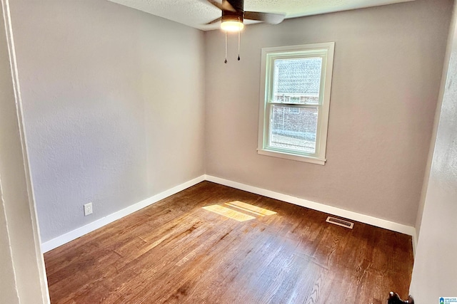 2912 Moore Ave, Anniston, AL 36201 - unfurnished room featuring wood finished floors, baseboards, ceiling fan, and a textured ceiling