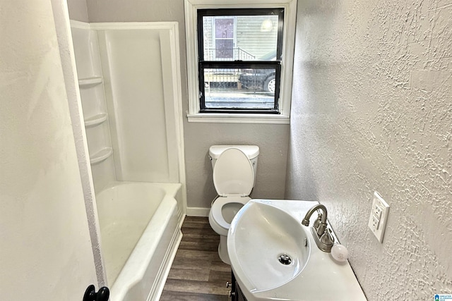 2912 Moore Ave, Anniston, AL 36201 - full bathroom featuring wood finished floors, a textured wall, vanity, toilet, and baseboards