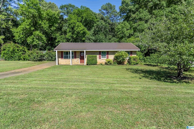 209 Meadowgreen Dr, Montevallo, AL 35115 - ranch-style house featuring a front yard, metal roof, driveway, and a forest view
