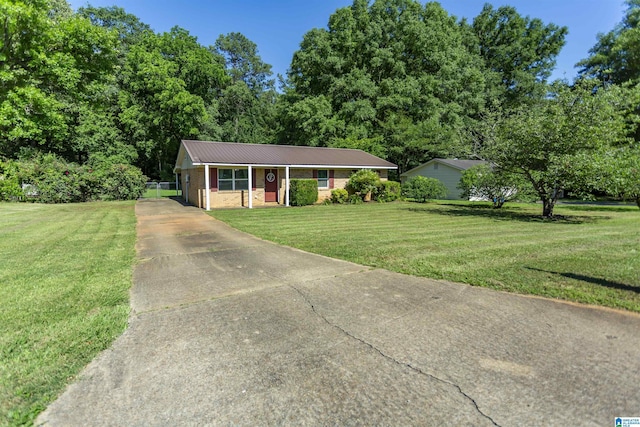 209 Meadowgreen Dr, Montevallo, AL 35115 - single story home with concrete driveway, a front yard, metal roof, and brick siding