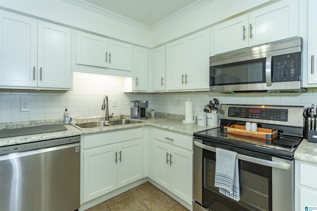 209 Meadowgreen Dr, Montevallo, AL 35115 - kitchen featuring appliances with stainless steel finishes, a sink, crown molding, backsplash, and light tile patterned floors