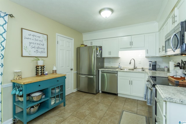 209 Meadowgreen Dr, Montevallo, AL 35115 - kitchen with appliances with stainless steel finishes, a sink, white cabinetry, tasteful backsplash, and wood counters
