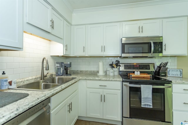 209 Meadowgreen Dr, Montevallo, AL 35115 - kitchen with appliances with stainless steel finishes, a sink, tasteful backsplash, ornamental molding, and white cabinetry