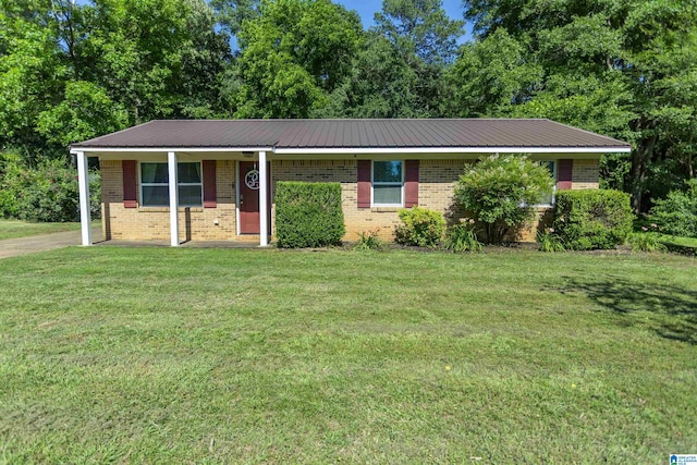 209 Meadowgreen Dr, Montevallo, AL 35115 - view of front of home featuring brick siding, a front lawn, and metal roof