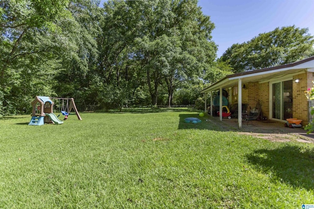 209 Meadowgreen Dr, Montevallo, AL 35115 - view of green lawn with a playground and a patio area