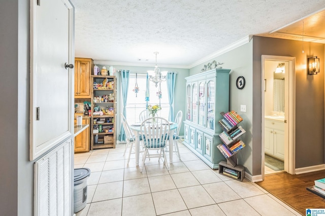 736 Buena Vista Loop, Prattville, AL 36067 - dining area featuring a chandelier, light tile patterned floors, ornamental molding, baseboards, and a textured ceiling