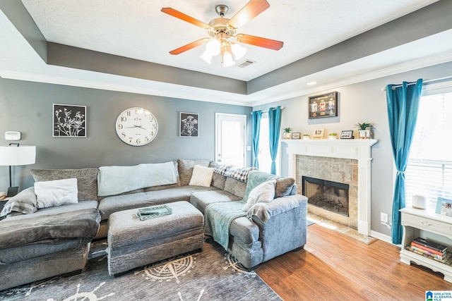 736 Buena Vista Loop, Prattville, AL 36067 - living room featuring a fireplace, wood finished floors, a ceiling fan, baseboards, and plenty of natural light