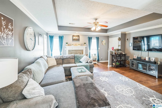 736 Buena Vista Loop, Prattville, AL 36067 - living room with a raised ceiling, a ceiling fan, a textured ceiling, wood finished floors, and crown molding