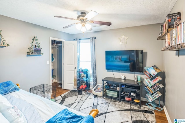 736 Buena Vista Loop, Prattville, AL 36067 - bedroom featuring wood finished floors, a textured ceiling, a spacious closet, ceiling fan, and a closet